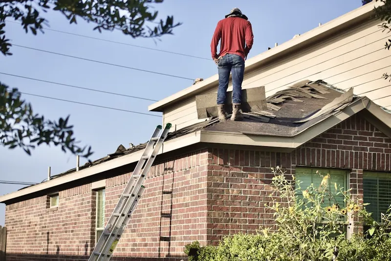 Professional roofer working on a residential roof in Rock Creek Palisades
